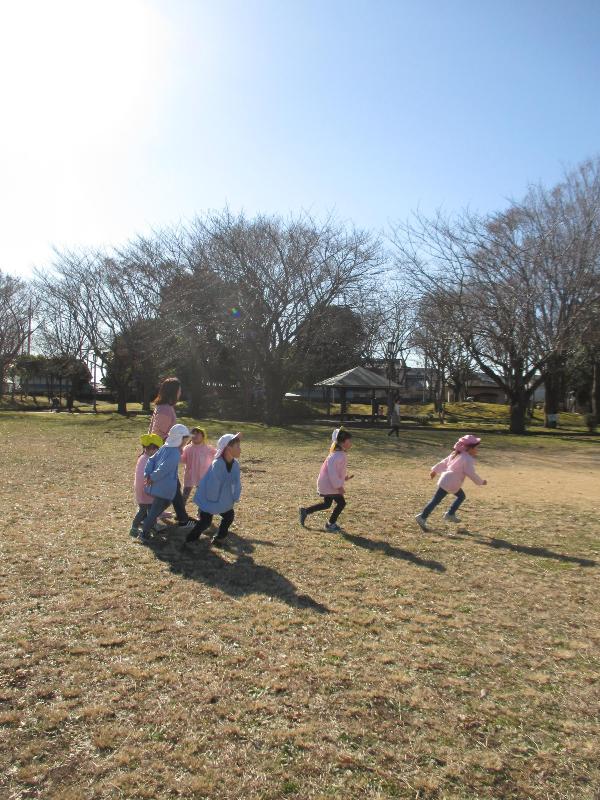 写真：先生の手をひいて遊んでいる様子