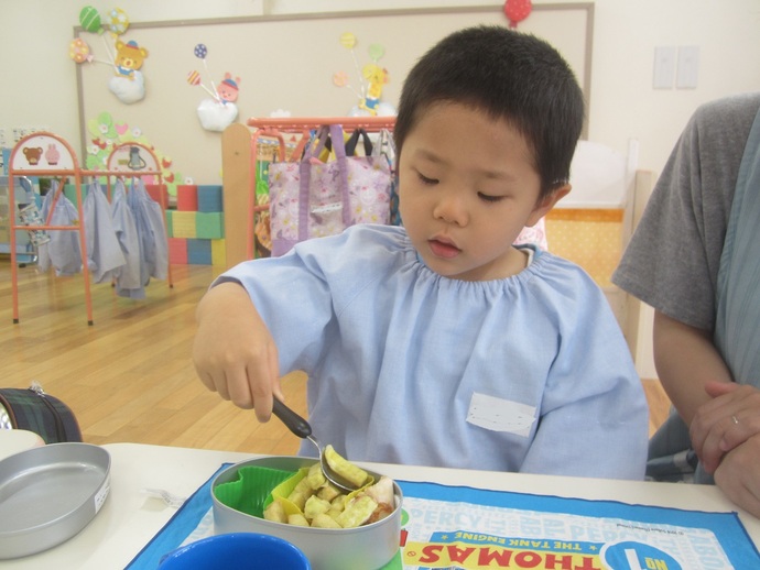 写真 お弁当を食べる男児