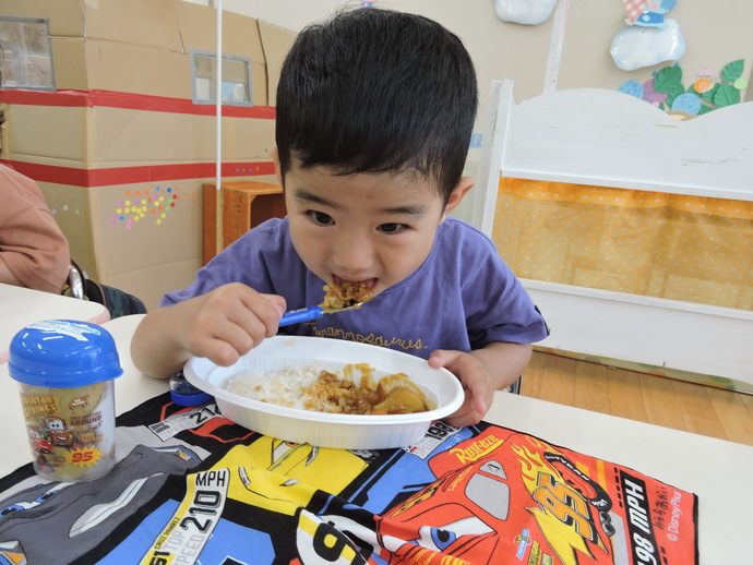 写真 カレーをほおばる年少児