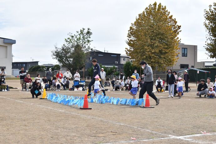 波に見立てた平テープを跳ぶ親子