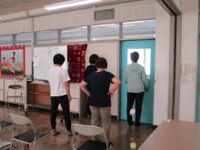 写真:ふくらはぎにトイレットペーパーを挟んでかかとの上げ下げをしている様子